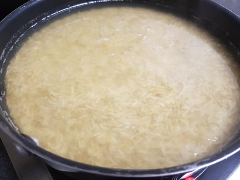 Brown basmati rice cooking in a non-stick pan