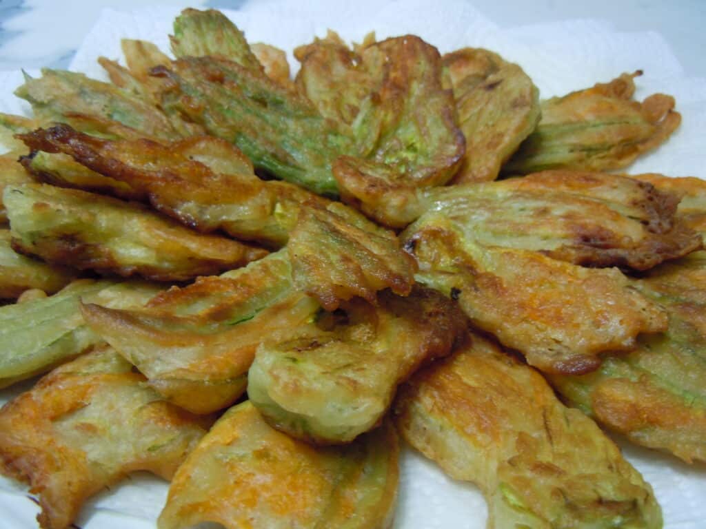 A close up image of fried courgette flowers.