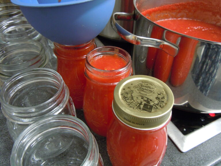 filling jars with homemade tomato sauce