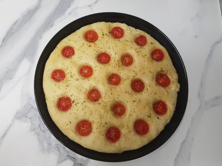 A cherry tomato and oregano focaccia ready to go in the oven