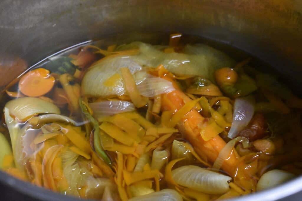 Homemade vegetable broth in a saucepan.