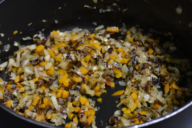 Sautéed onion, radicchio and hokkaido pumpkin in a frying pan