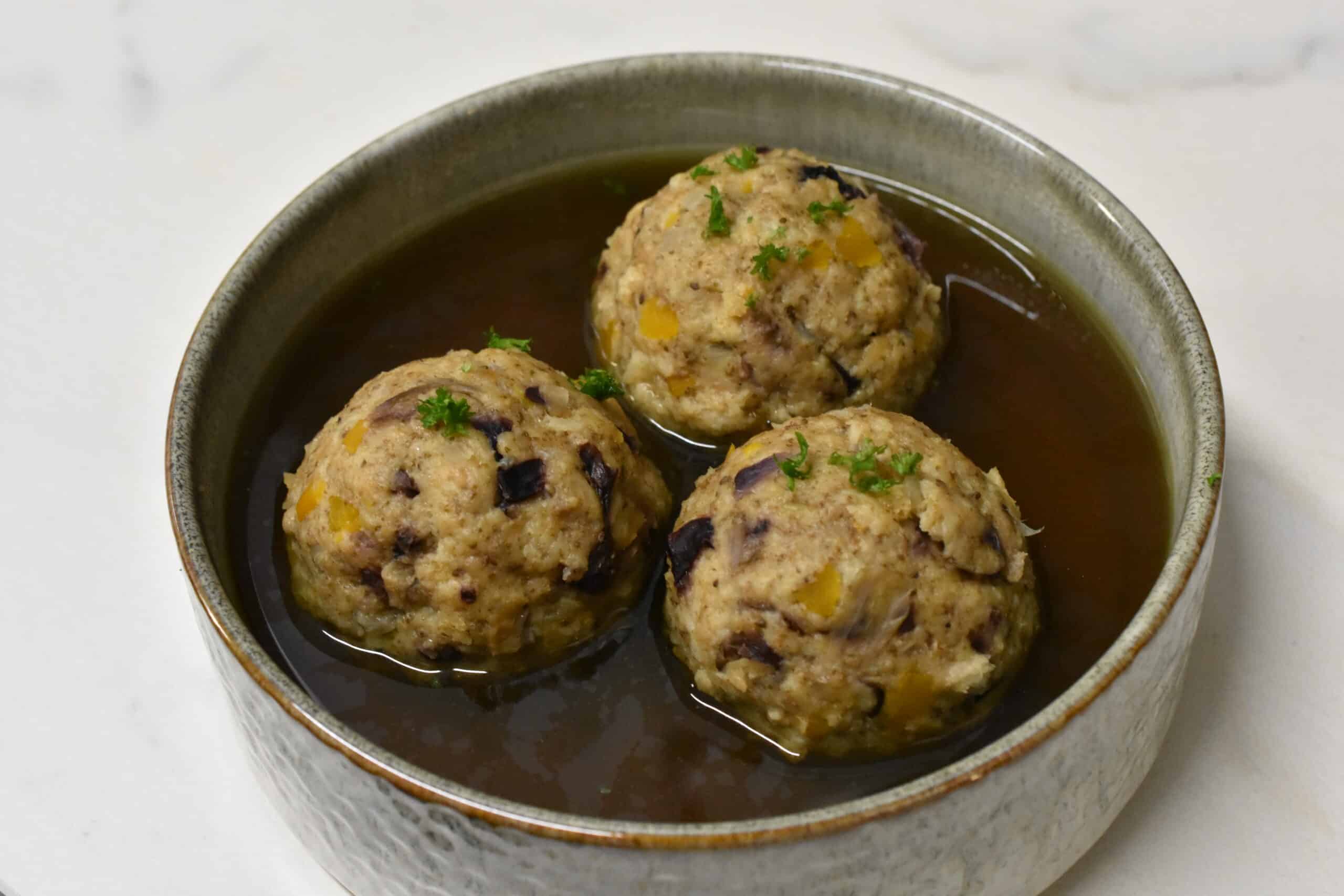 Vegan canederli in vegetable broth in a bowl