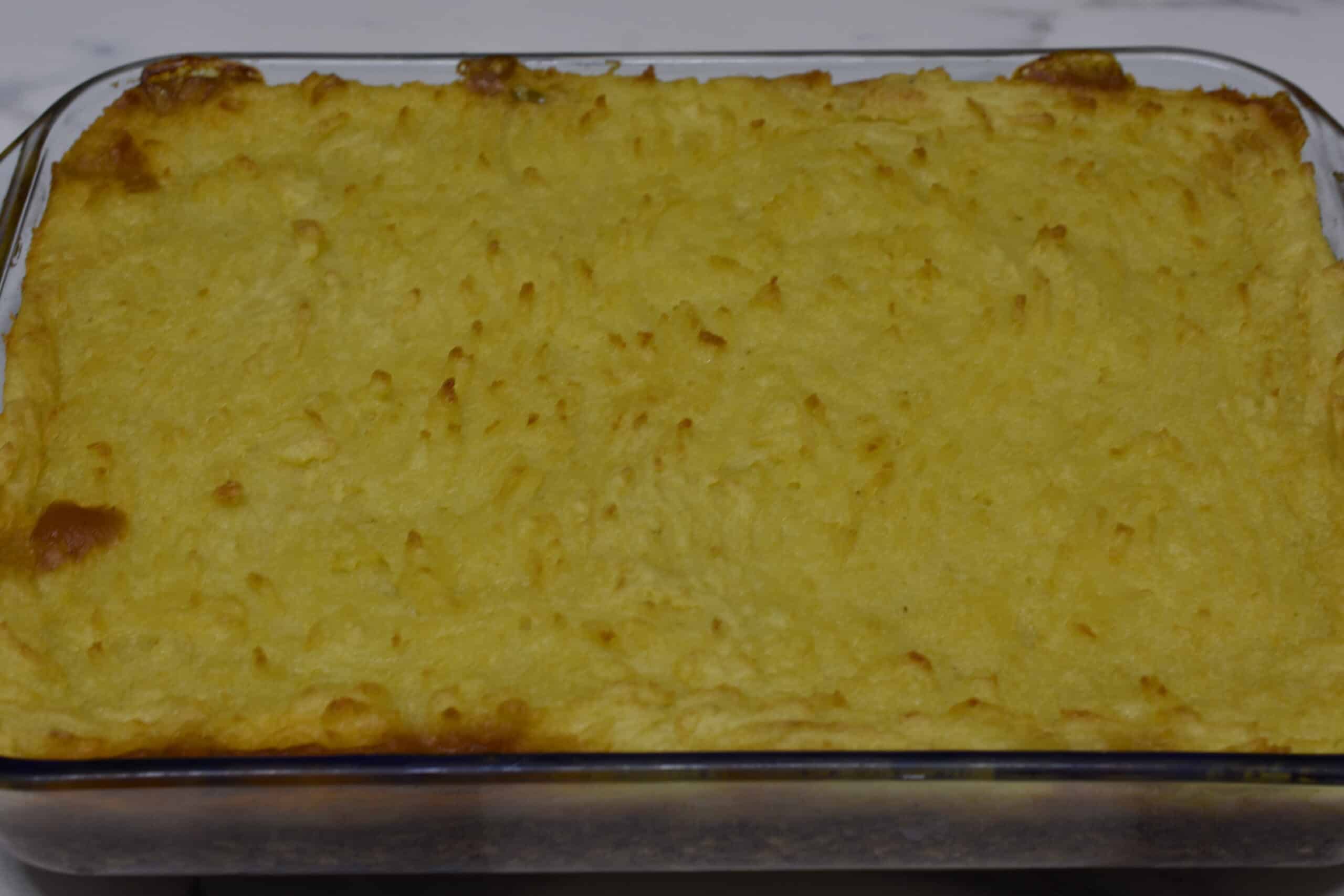 Vegan shepherd's pie in a transparent rectangular Pyrex dish