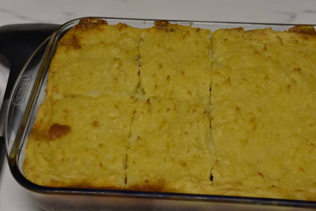 Portions of vegan shepherd's pie in a transparent rectangular Pyrex dish