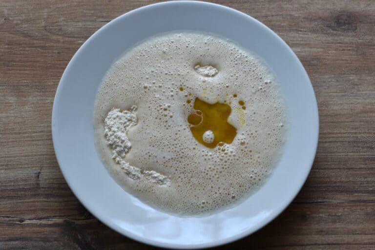 All-purpose flour, rice flour, salt, oil and beer (ingredients for beer batter) in a bowl.