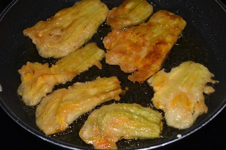 Courgette flowers shallow fried on both sides in sunflower oil in a non-stick pan.