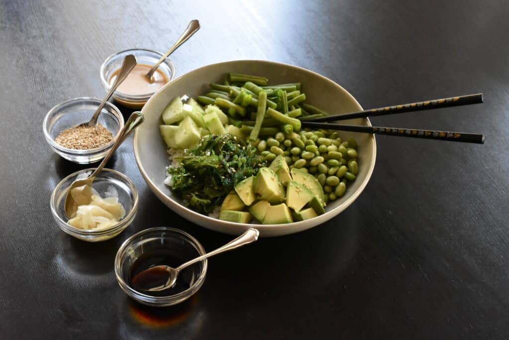 Buddha bowl with avocado, wakame and edamame beans.