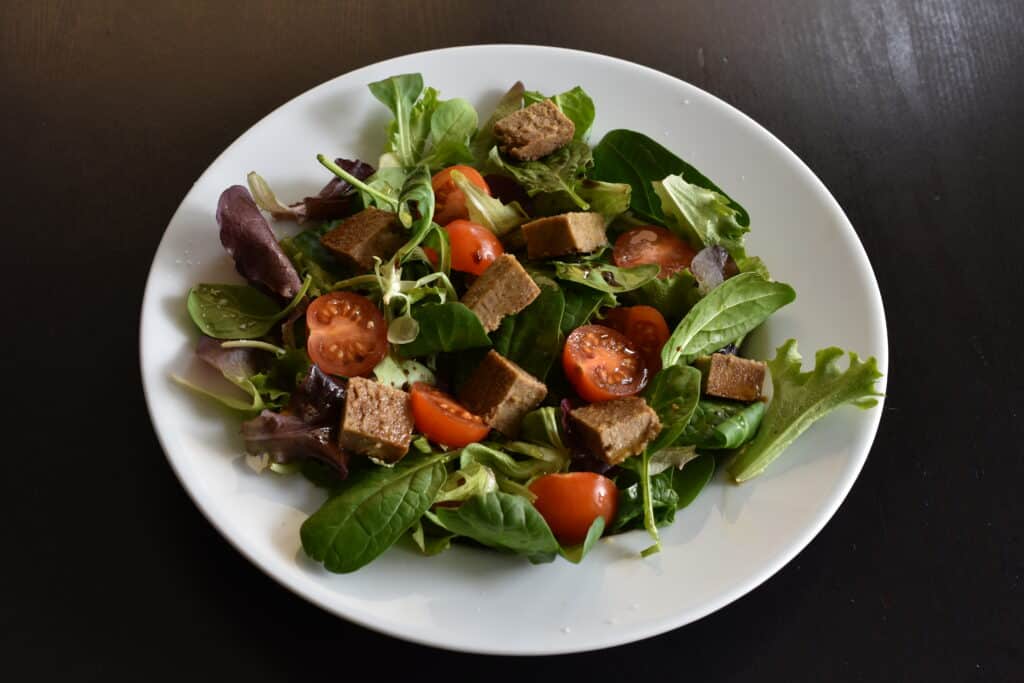 Mixed salad with vegan nut roast and cherry tomato halves