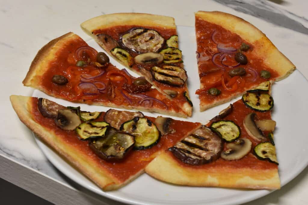 Five slices of vegan pizza on a plate