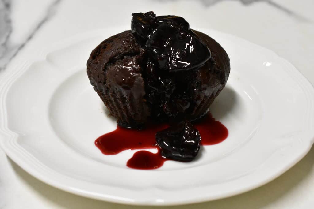 Vegan chocolate muffin with hot cherry sauce