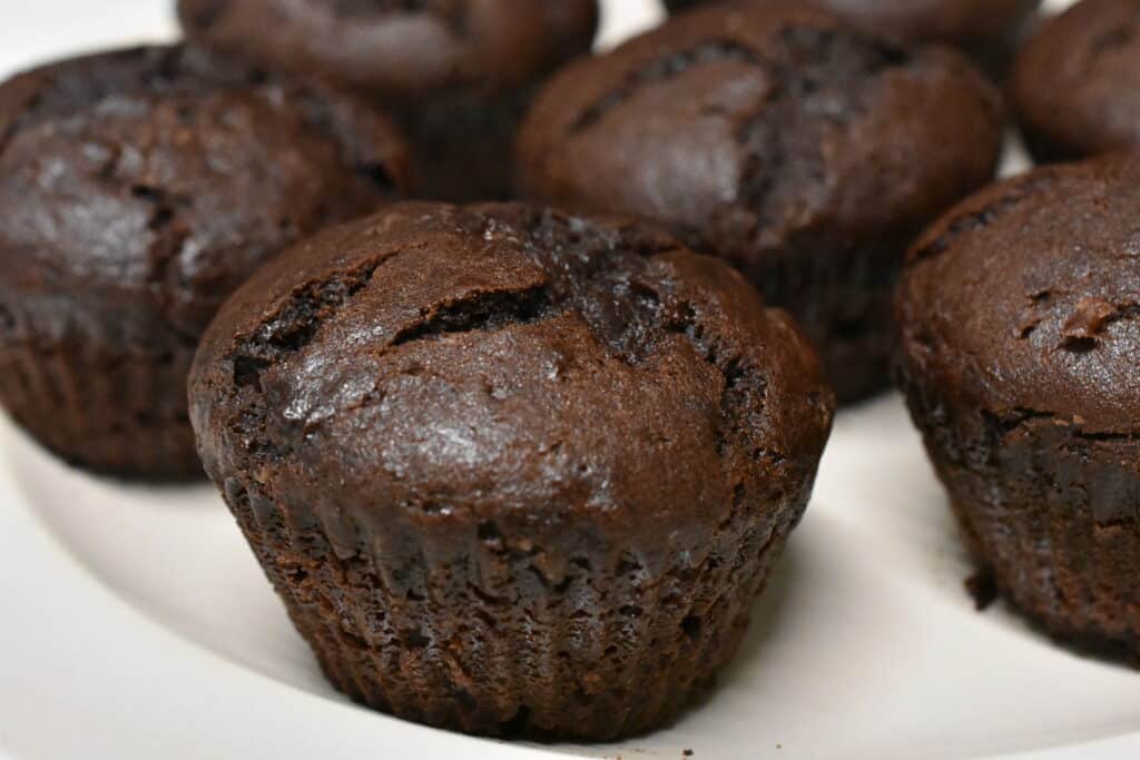 Close-up image of vegan chocolate muffins on white plate