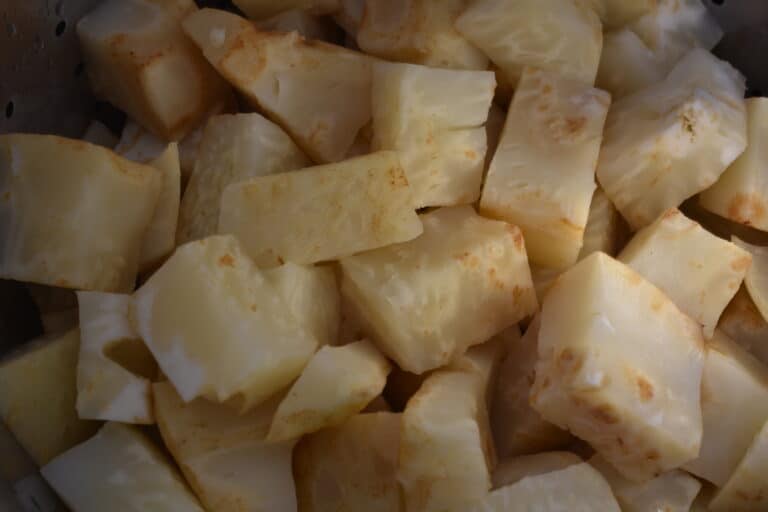 Cubes of steamed celeriac in a steamer