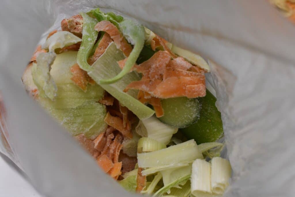 Frozen vegetable scraps in a bag.