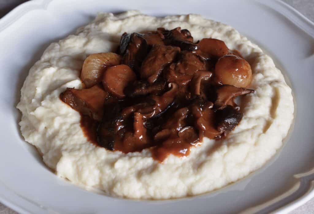 Mushroom bourguignon in a well of vegan celeriac mash.