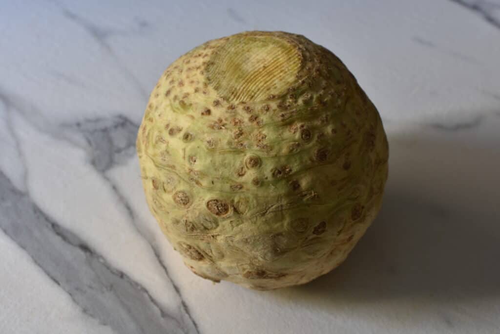 A whole celeriac on a kitchen worktop