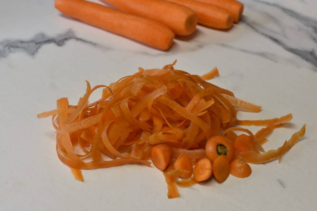 Carrot peelings on a kitchen worktop.