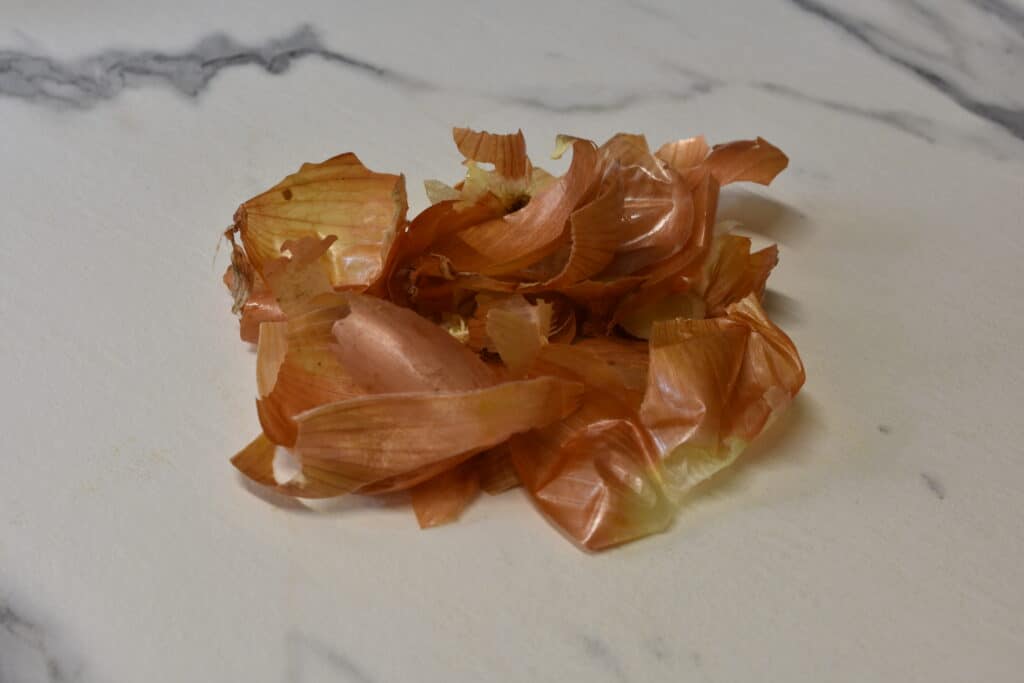 Dried onion skins on a worktop.