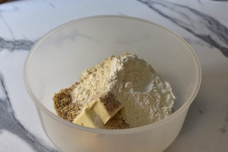 Vegan butter, sugar, ground almonds, flour, salt and vanilla in a bowl.