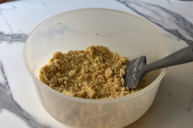 Flour, ground almonds, butter and sugar, mixed together in a bowl.