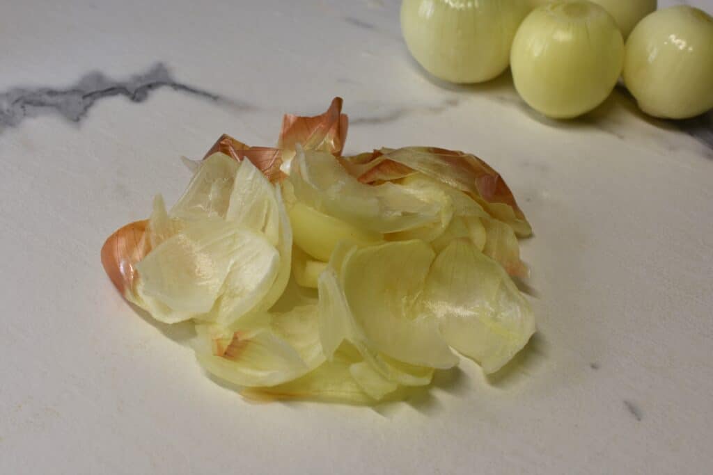 Outer layers of onion skins on kitchen worktop.