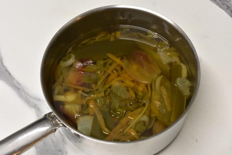 Vegetable scraps simmering in a pan to make vegetable broth.