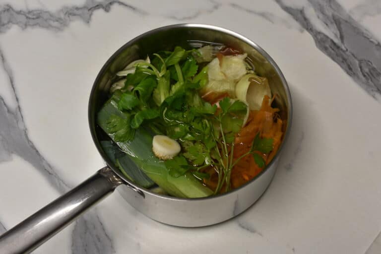 Vegetable scraps for broth in a saucepan