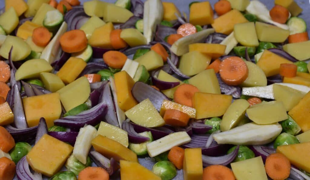 Raw winter vegetables on an oven tray.