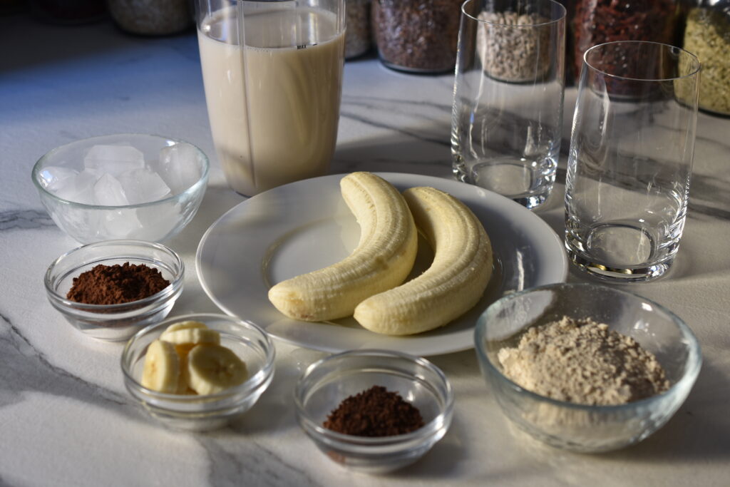 Ingredients for vegan chocolate and banana protein shake.