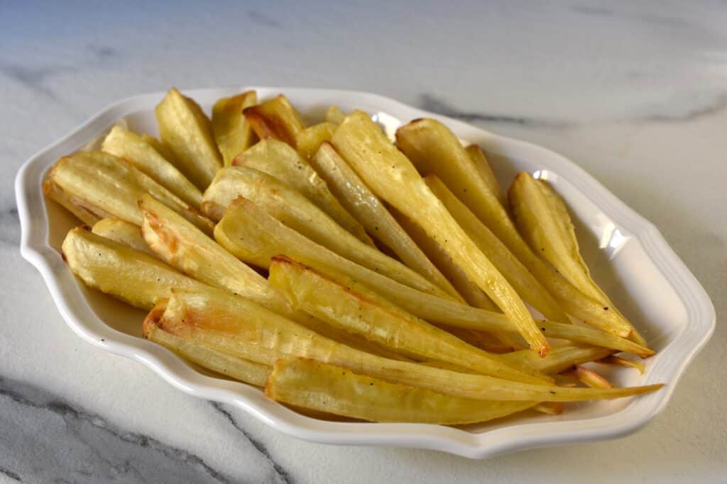 Oven-roasted parsnips on a white serving plate