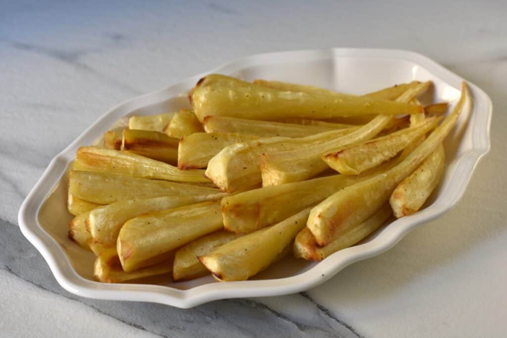 Parsnip chips on a white serving plate