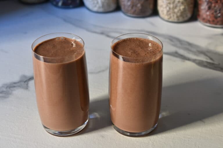 Vegan chocolate banana protein shake in two 400 ml glasses.