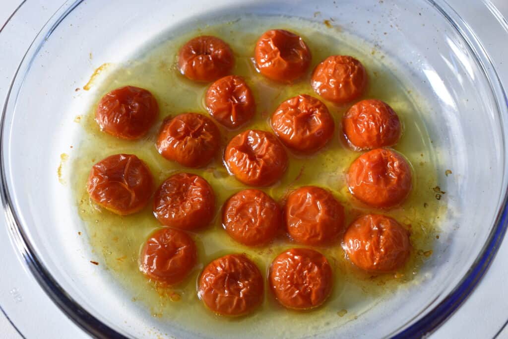 Oven-roasted cherry tomato halves in a glass Pyrex dish