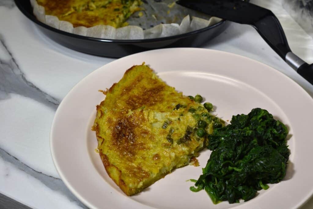 Two slices of farinata with spinach side dish