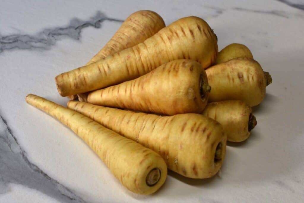 Whole parsnips on a kitchen worktop