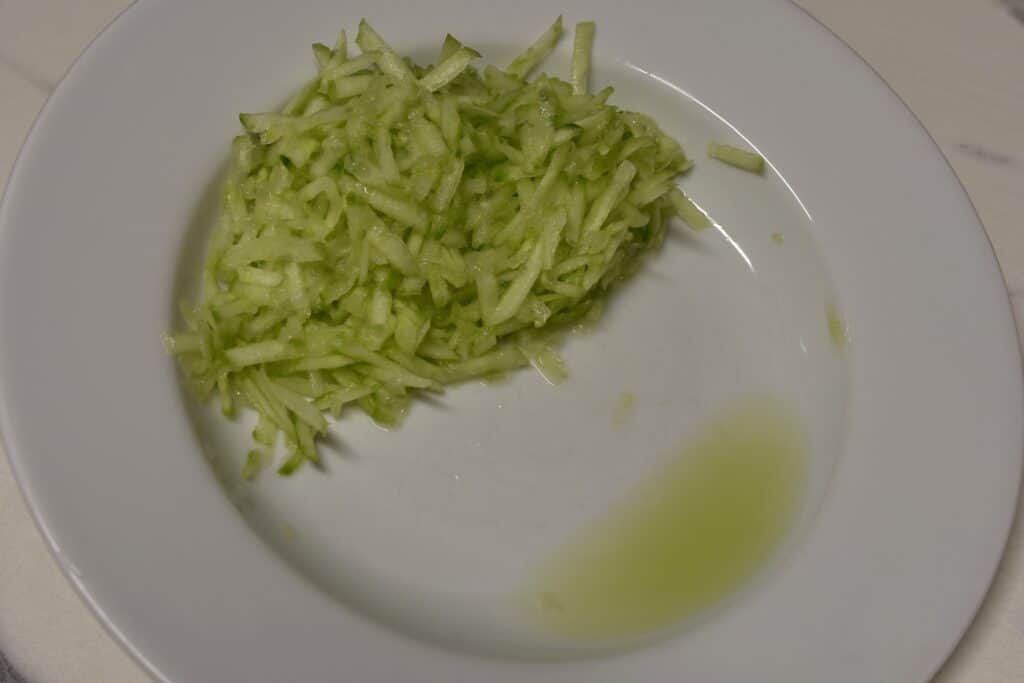 Draining cucumber in a white bowl