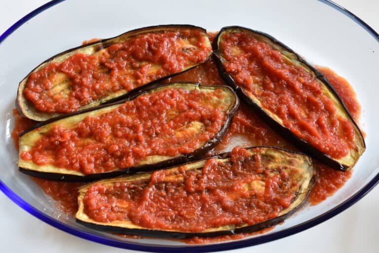 Spread a thin layer of tomato sauce on the aubergine slices