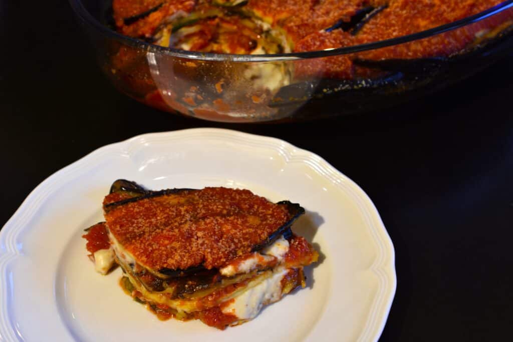 Vegan-aubergine-parmigiana-with-a-serving-dish-in-the-background