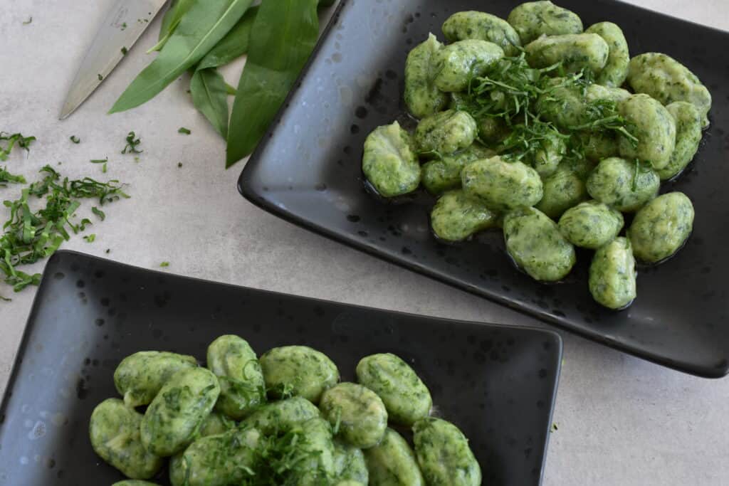 2 plates of vegan wild garlic gnocchi.