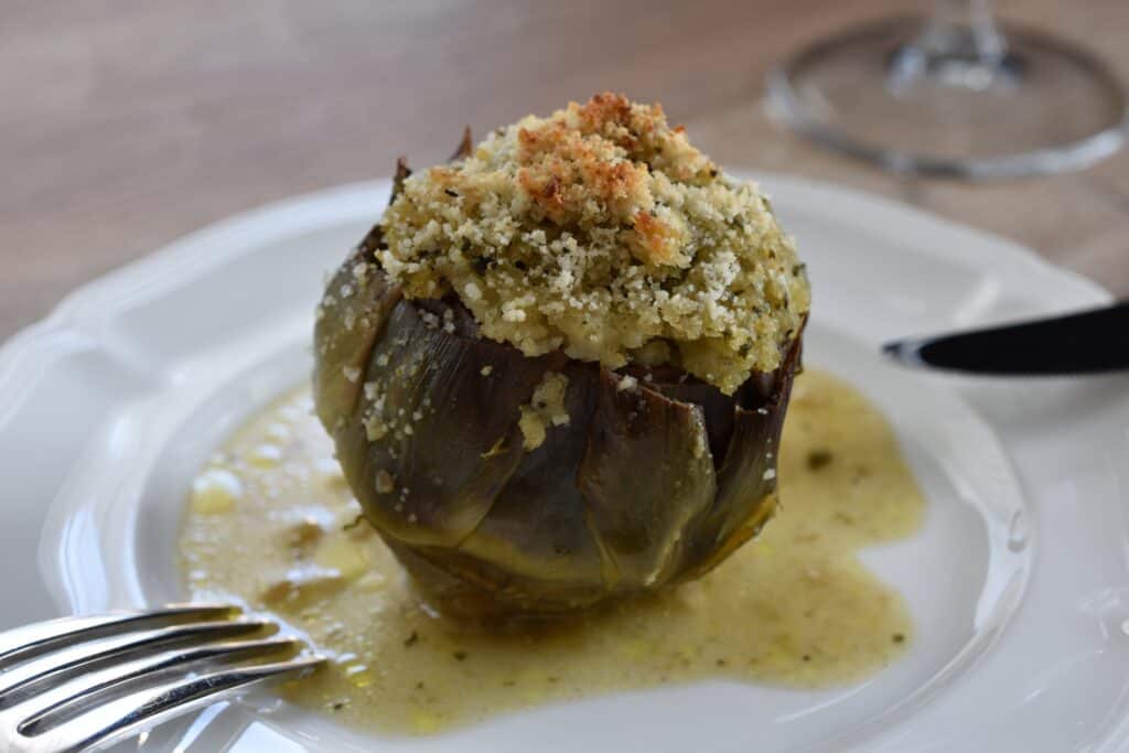 A close-up image of a stuffed artichoke.