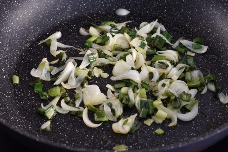 Cooked spring onions in a pan