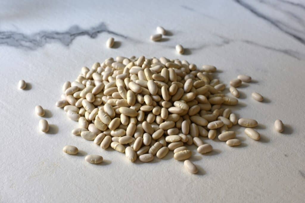 Dry cannellini beans on a kitchen worktop