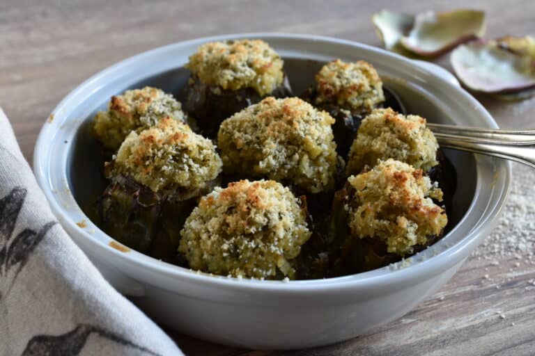 Vegan stuffed artichokes in an oven dish.