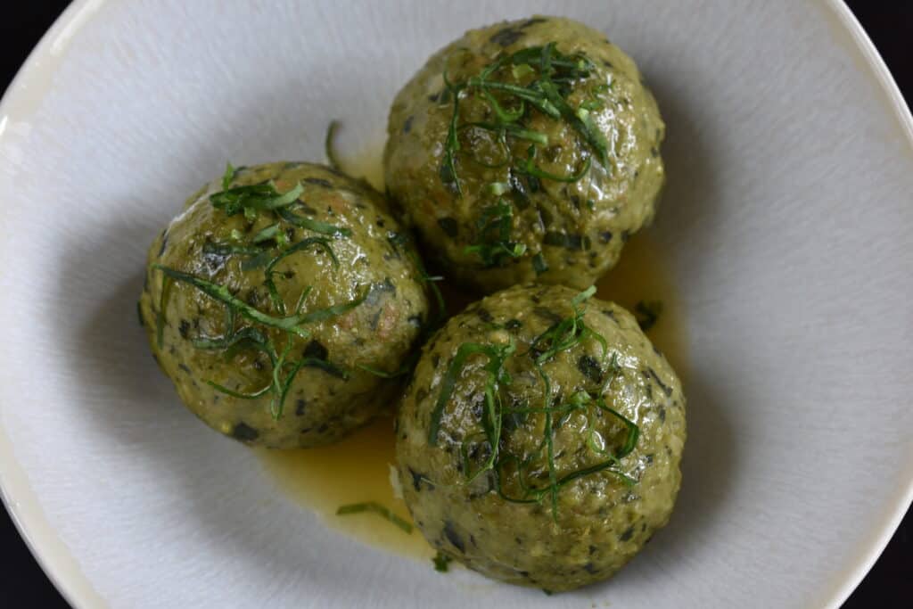 Vegan wild garlic bread dumplings (canederli) with melted vegan butter.