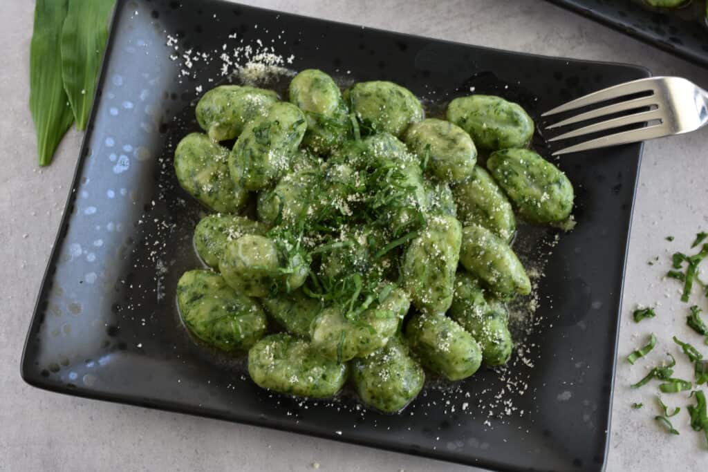 Vegan wild garlic gnocchi with a sprinkling of vegan parmesan cheese.