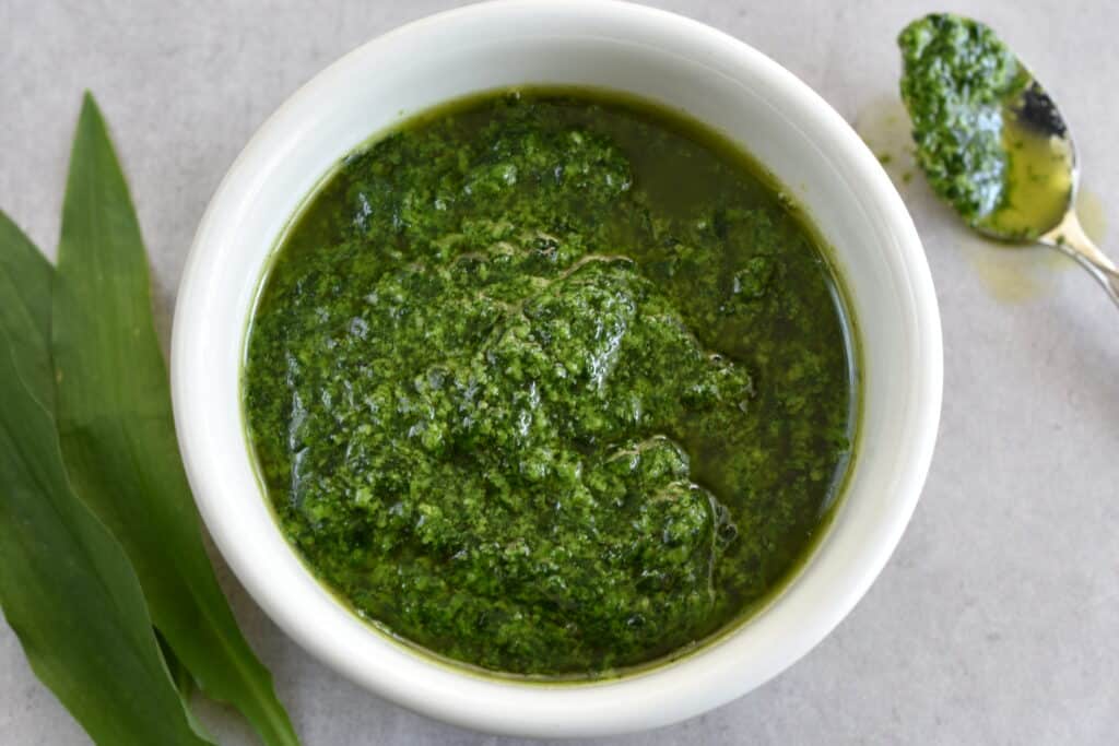 Vegan wild garlic pesto made with a mortar and pestle.