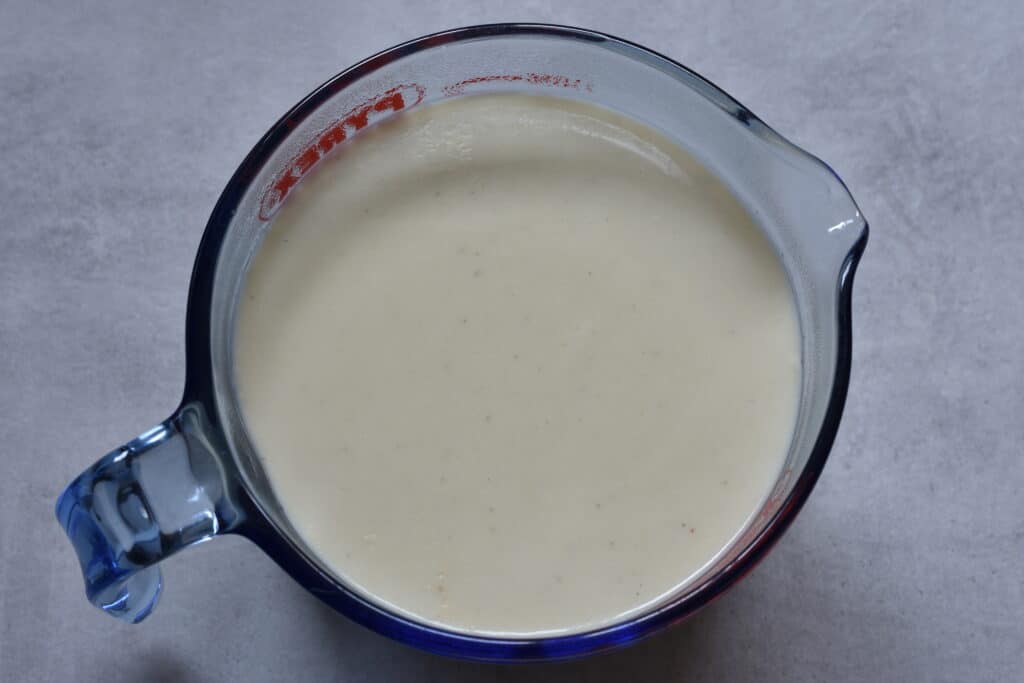 Vegan béchamel sauce (white sauce) in a jug