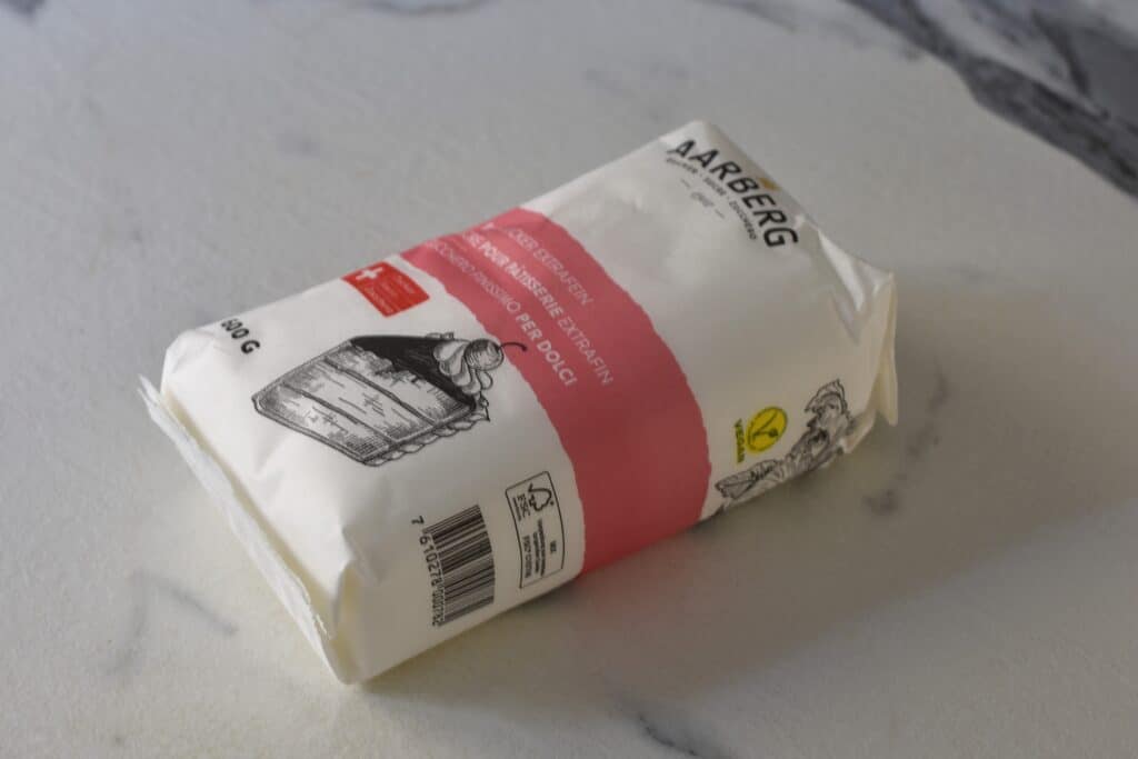 A packet of Aarberg vegan white sugar on a kitchen worktop.