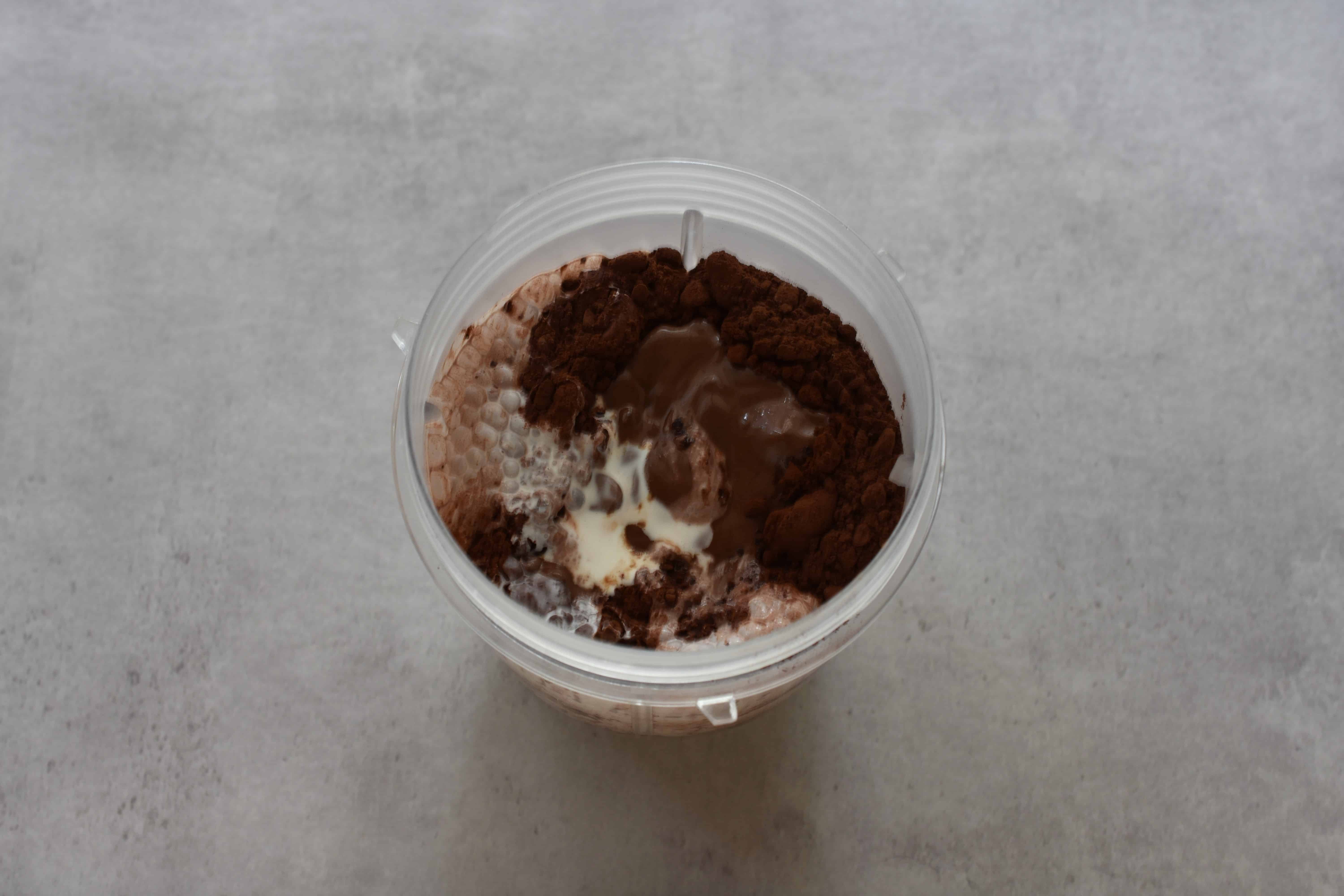 Ingredients for vegan dark chocolate ice cream in a blender beaker.