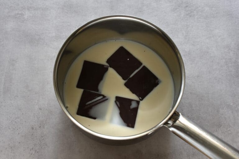 Vegan dark chocolate and plant-based milk in a saucepan.